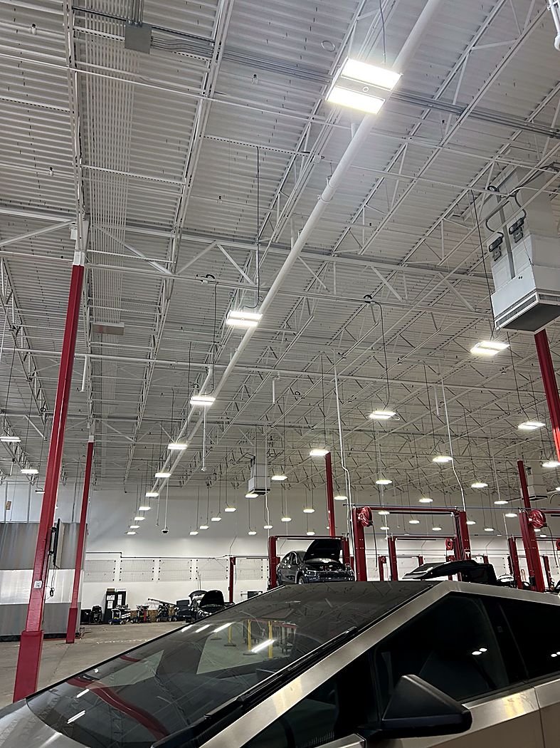 Rows of LED high-bay fixtures in a service shop
